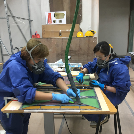 Wong Yan-yan (right) restoring a section of the stained glass windows at Haw Par Mansion